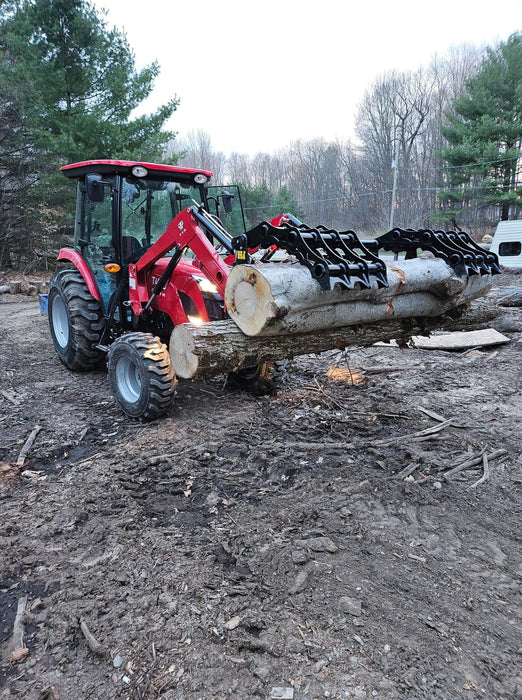 Heavy-duty compact tractor grapple bucket by Stinger gripping debris – durable attachment ideal for landscaping, farming, and cleanup work.