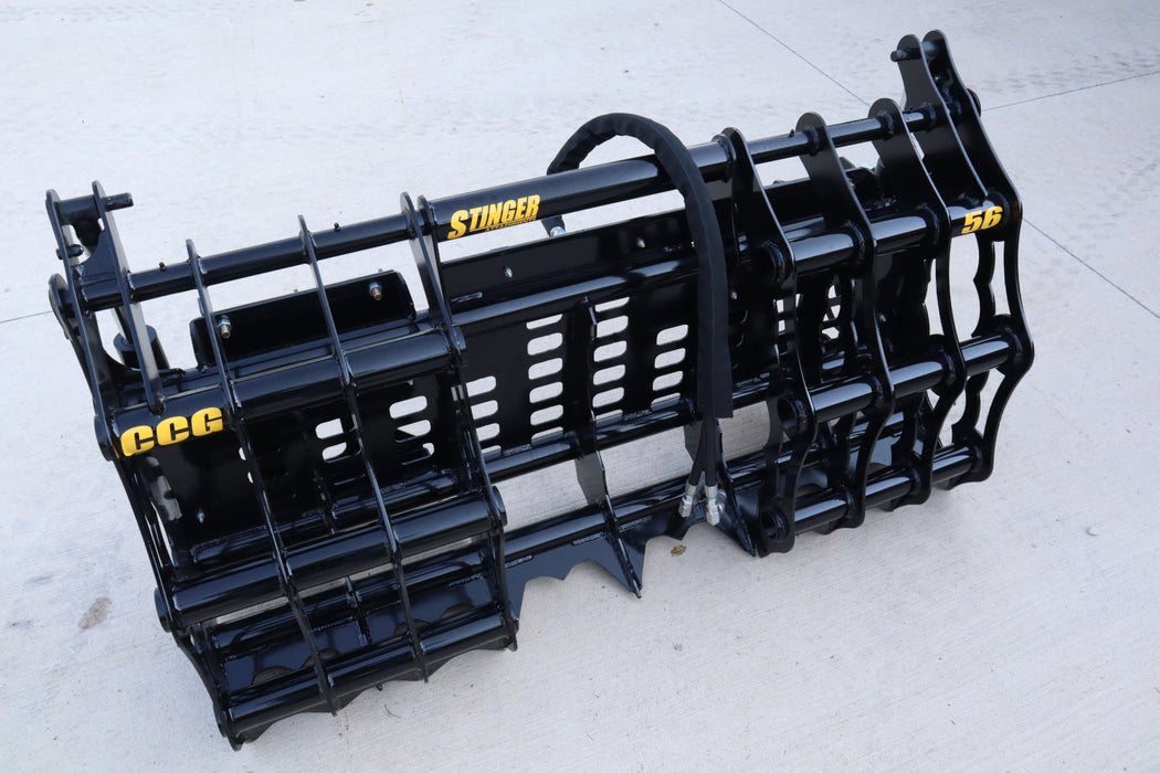 Stinger compact tractor grapple bucket lifting logs and brush – heavy-duty clam design built for efficient land clearing and material handling.