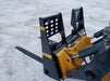 Side view of Stinger skid steer pallet forks mounted on loader – dependable attachment for precise material positioning.