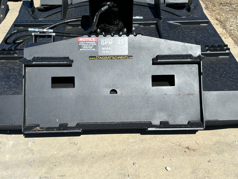 Heavy-duty skid steer disc mulcher by Stinger clearing undergrowth – professional forestry tool engineered for strength and precision.