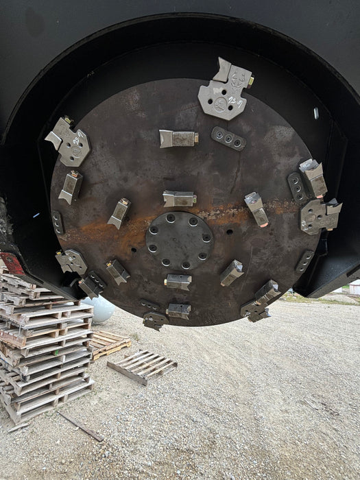 Front view of Stinger Decimator skid steer disc mulcher engaging dense vegetation – rugged attachment built for power and endurance.