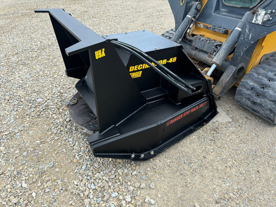 Stinger Decimator skid steer disc mulcher in action shredding trees – precision-engineered for maximum efficiency and power.