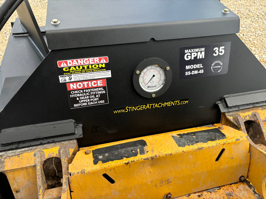 Forestry professional operating Stinger Decimator skid steer disc mulcher – efficient equipment for vegetation and underbrush removal.