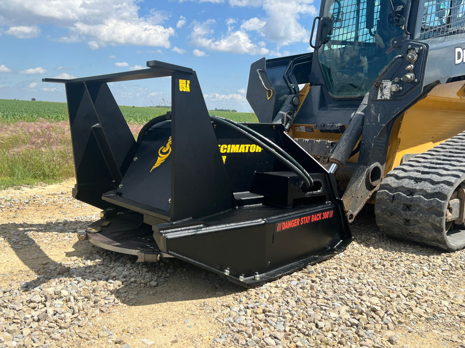 Powerful skid steer disc mulcher by Stinger grinding vegetation on rugged terrain – ideal for land clearing and forestry management.