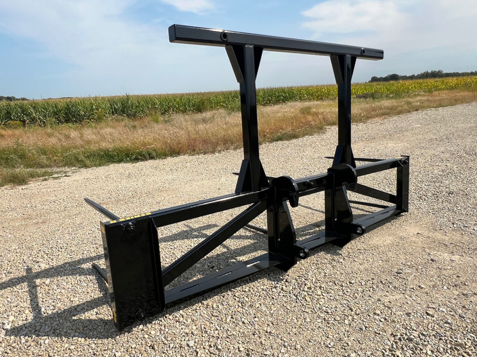 Side profile of the Series 5XD Bale Spear attached to a tractor loader for efficient hay transport.