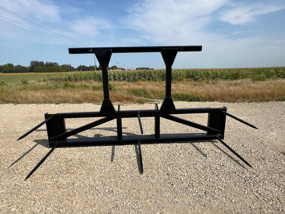 Operator using Stinger multi-bale spear on skid steer to lift multiple hay bales – rugged design ensures efficient handling and transport.