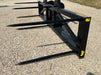 Stinger Series 5XD bale spear mounted on skid steer – professional-grade tool for moving, stacking, and feeding large hay bales.