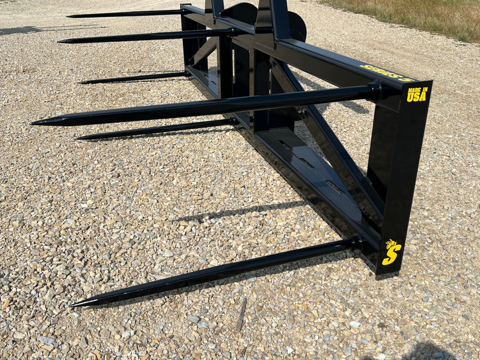 Stinger Series 5XD bale spear mounted on skid steer – professional-grade tool for moving, stacking, and feeding large hay bales.