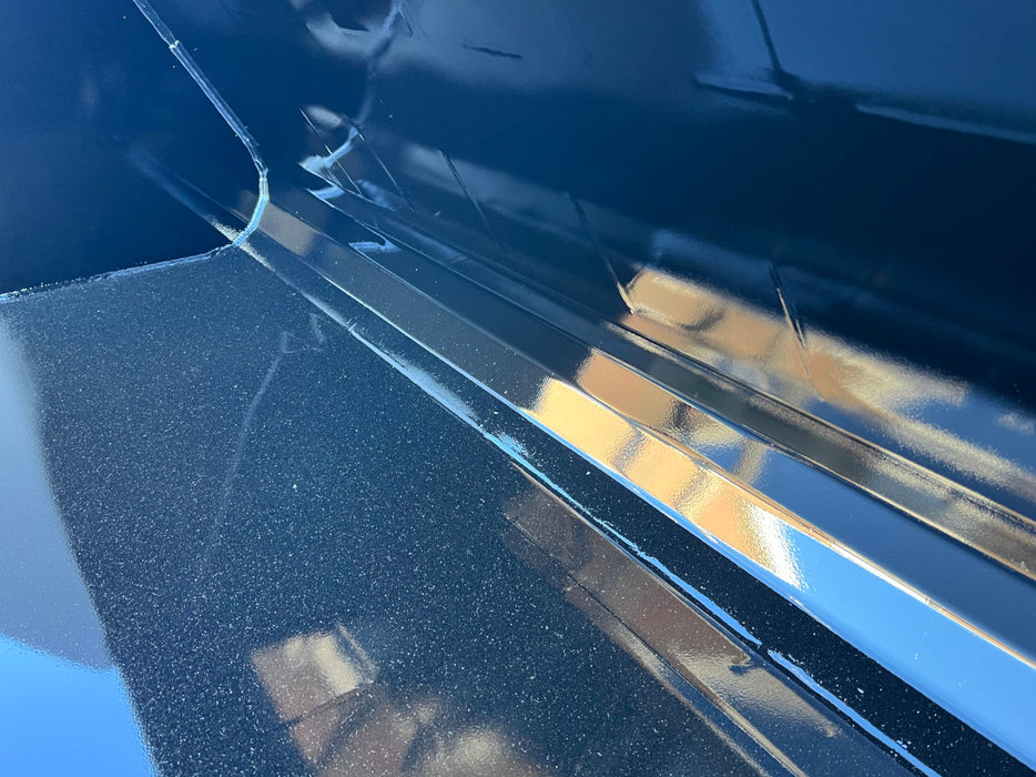 Side view of skid steer manure bucket in action – durable farm attachment engineered for productivity and control.