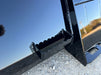 Skid steer manure bucket by Stinger removing slurry from feedlot – reliable design for smooth operation and easy cleanup.