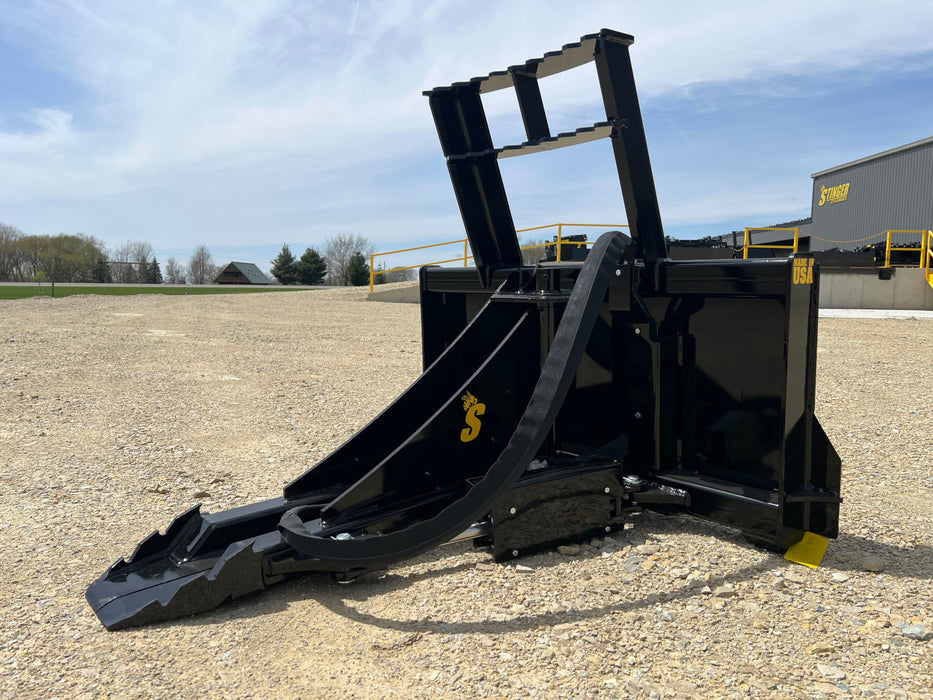 Stinger skid steer tree puller attachment in action removing saplings – heavy-duty tool built for power, control, and durability.