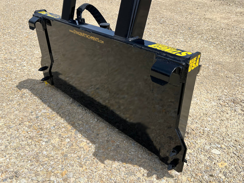 Heavy-duty compact tractor tree puller removing brush and saplings – durable jaws built for precision and power on any terrain.