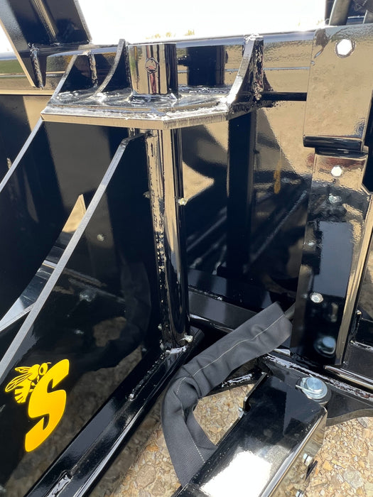 Operator using compact tractor tree puller to uproot trees – reliable attachment ideal for landscaping, forestry, and farm clearing.