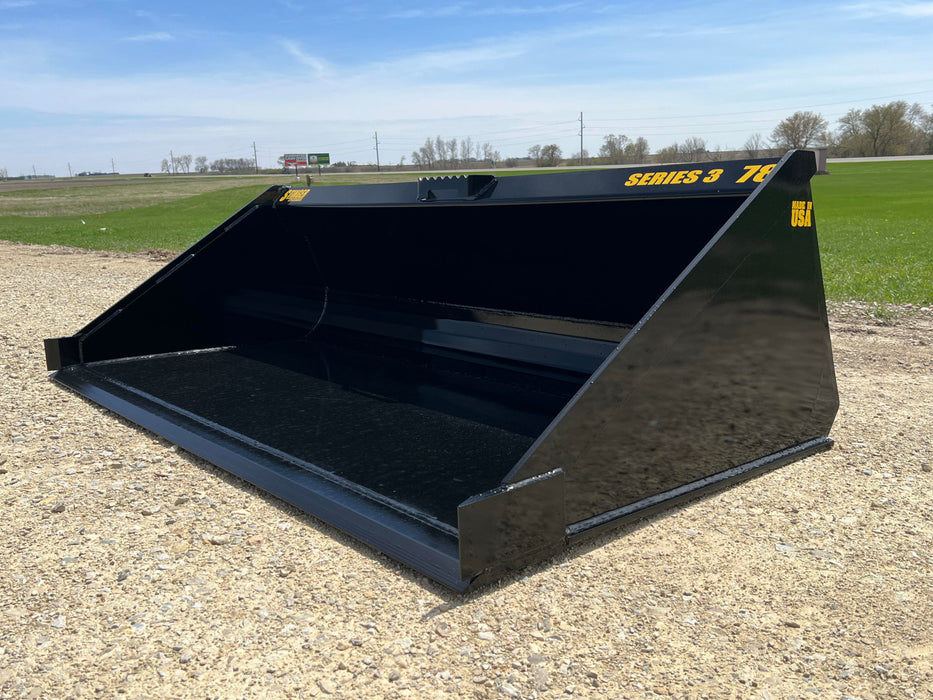 Side view of Stinger skid steer material bucket in action – rugged and versatile tool for commercial and agricultural applications.