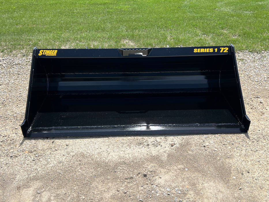 Side view of Stinger skid steer material bucket in operation – efficient and rugged design for daily construction and agricultural use.