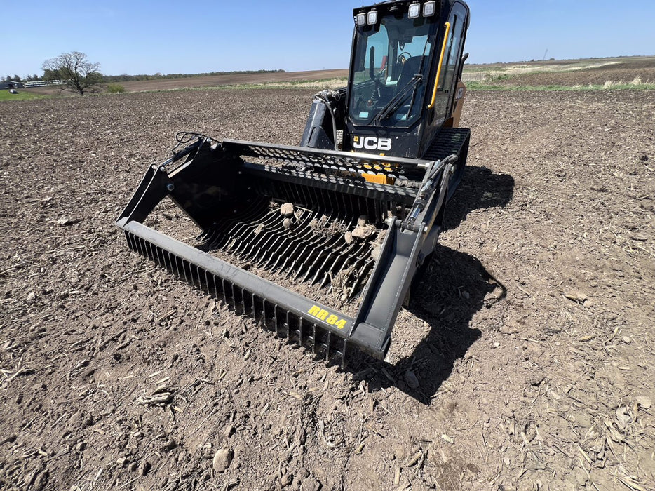 Close-up of skid steer rock reel tines and reinforced drum – heavy-duty construction ensures reliable performance on tough jobs.