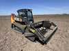 Heavy-duty skid steer rock reel attachment collecting rocks and debris – durable design engineered for efficient land clearing and cleanup.