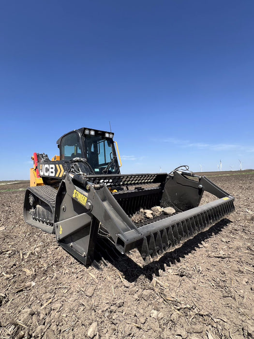 Stinger skid steer rock reel in action rolling and collecting stones – designed for smooth operation and high efficiency.