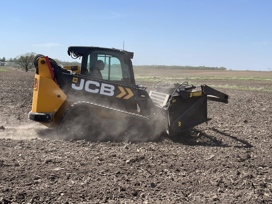 Stinger skid steer rock reel lifting compacted rocks – reinforced grapple bucket ensures strength, durability, and precision.