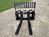 Stinger skid steer pallet forks carrying lumber and heavy supplies – robust attachment ideal for industrial and agricultural use.