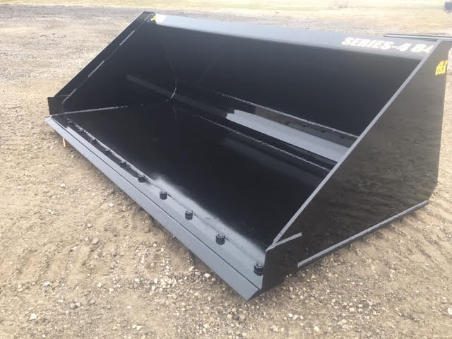 Heavy-duty skid steer material bucket by Stinger carrying compacted soil – durable Series 4 design engineered for professional-grade performance.