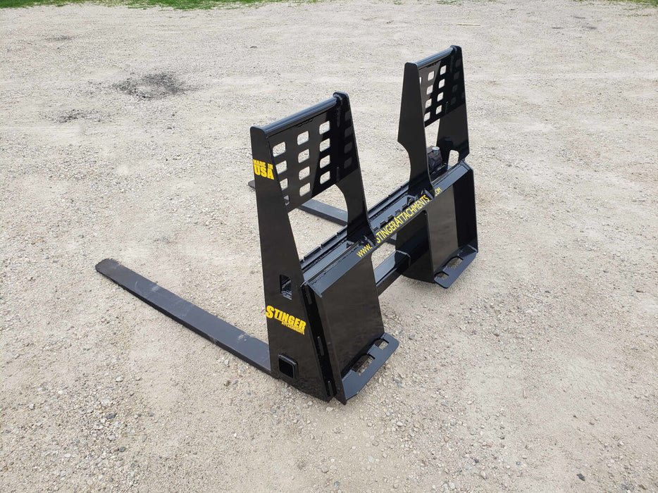 Heavy-duty skid steer pallet forks by Stinger lifting wooden pallet – durable attachment built for reliable material handling and transport.