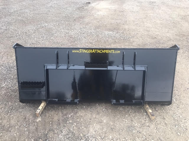 Durable Stinger skid steer material bucket moving sand and rocks – built for demanding work environments and consistent performance.