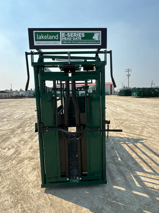 Farmer using the E-Series cattle squeeze chute to safely restrain and inspect livestock on a ranch
