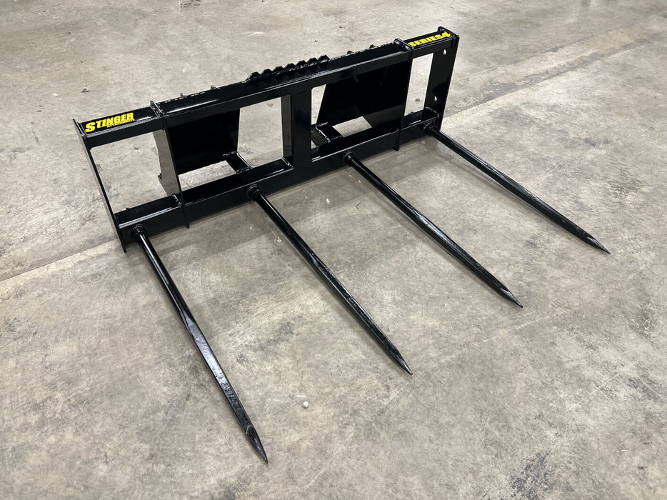 Stinger Series 4 bale spear lifting large square hay bales – heavy-duty attachment built for reliable farm use and efficient bale handling.