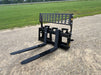 Side view of heavy-duty skid steer pallet forks by Stinger mounted on loader – designed for reliable performance on tough job sites.