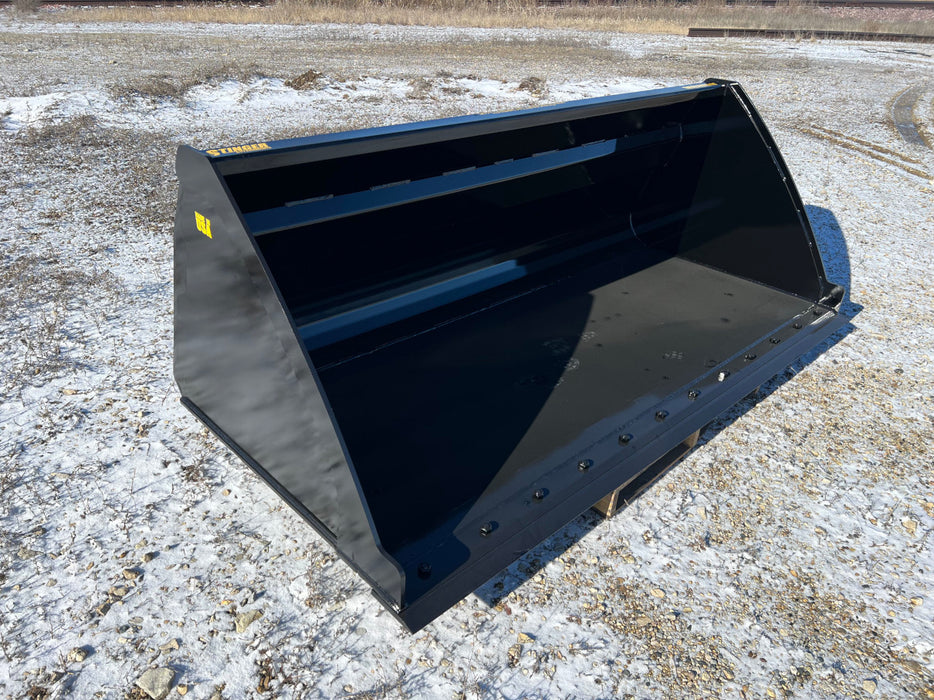 High capacity skid steer bucket lifting silage and feed – heavy-duty attachment designed for large material handling and farm use.