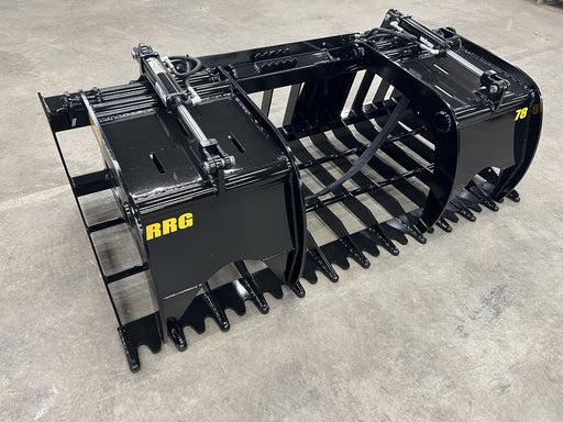 Heavy-duty Rock Grapple attachment mounted on a tractor lifting large rocks and roots during land clearing.