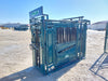 Cattle handler using Lakeland Cattle Squeeze Chute for safe livestock control