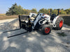 Heavy-duty skid steer pallet fork by Stinger lifting wooden pallet – durable attachment designed for efficient material handling and transport.