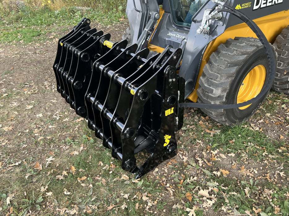 Close-up of the Clam Grapple jaws and hydraulic cylinders showing powerful grip and durable construction.