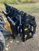 Industrial-grade Clam Grapple resting on gravel ground, highlighting heavy-duty design and robust hinge system.