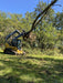 Front view of heavy-duty skid steer tree puller in action – precision-built jaws ensure secure grip and clean tree removal.