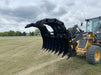 Close-up of the Stinger CG-XD tractor grapple bucket showing reinforced dual-arm clam design for maximum grip.