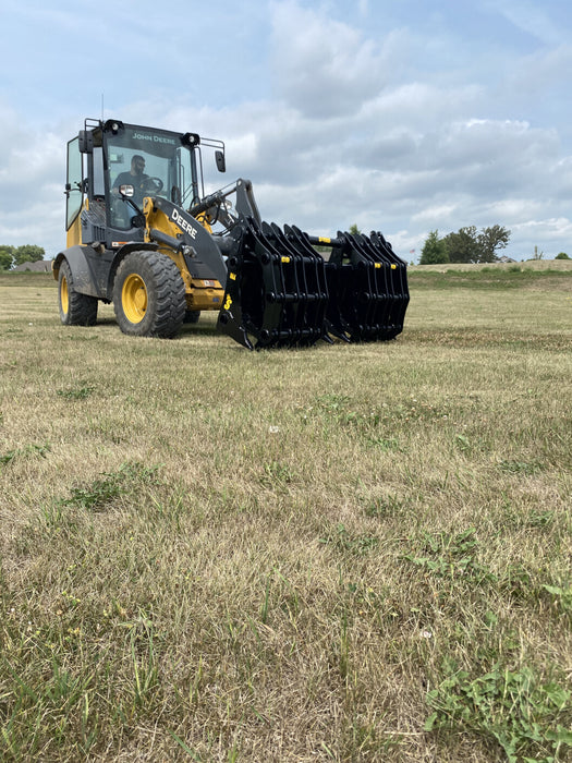 Front angle of the Stinger Attachments tractor grapple bucket demonstrating wide jaw opening and strong clamping force.