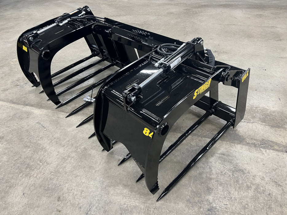 Stinger MG-Series skid steer manure grapple handling wet manure and hay – efficient tool for farm maintenance and cleanup operations.