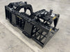 Industrial-grade Rock Grapple resting on gravel, highlighting durable tines and welded structural frame.