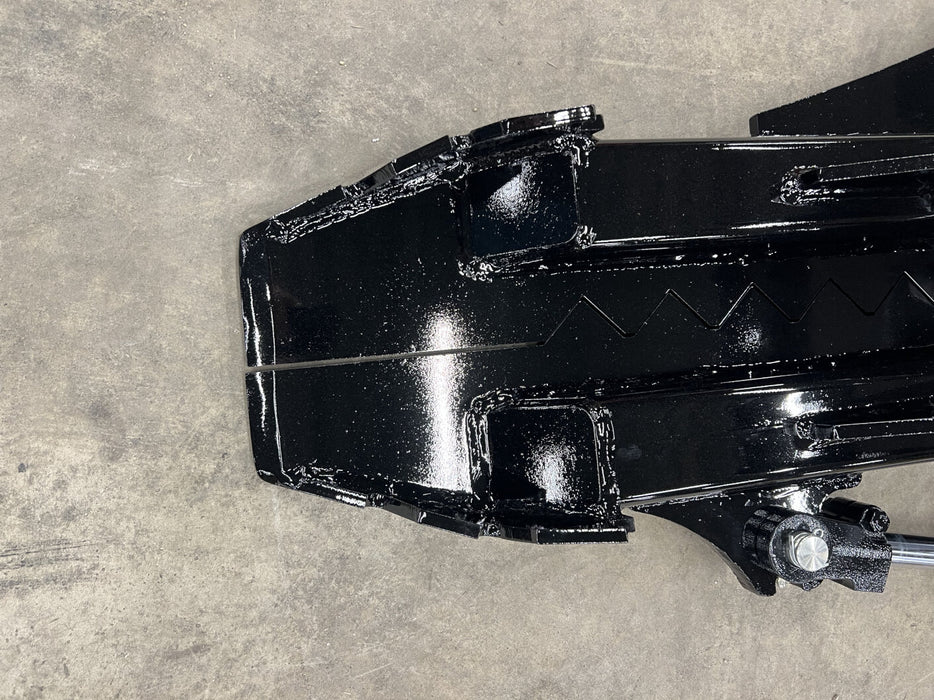 Stinger skid steer tree puller attachment removing saplings and shrubs – powerful tool for clearing vegetation and roots.