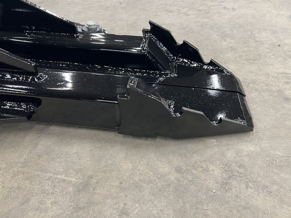 Side view of skid steer tree puller clamping tree stump – heavy-duty design built for stability, control, and maximum pulling force.