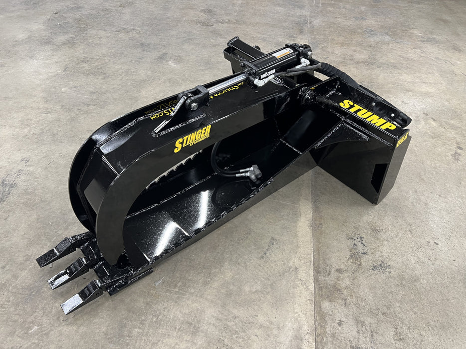 Tractor equipped with a Stump Grapple Bucket lifting uprooted stumps and debris on a construction site.