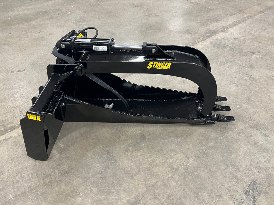 Front view of the Stump Grapple Bucket attachment mounted on a compact skid steer for efficient stump removal.