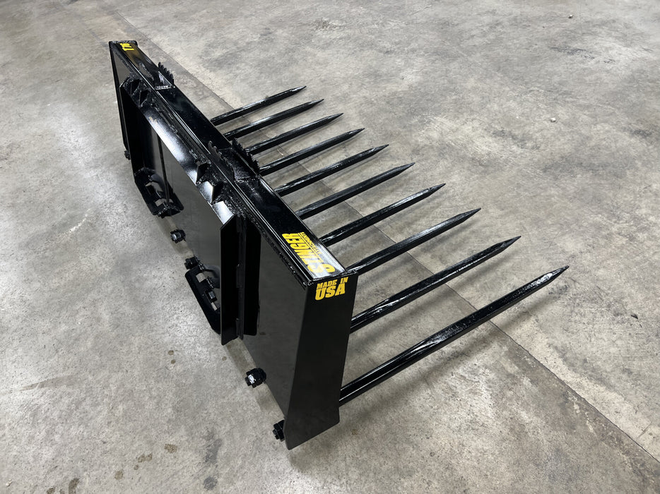 Operator using Stinger skid steer grapple bucket to move manure and straw – reliable tool built for tough farm and livestock operations.