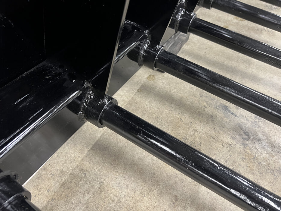 Front view of Stinger manure spear skid steer grapple bucket in action – powerful attachment ideal for feeding, cleaning, and transport tasks.