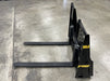Heavy-duty skid steer pallet forks by Stinger handling heavy loads – ideal for farming, landscaping, and industrial applications.