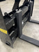 Front view of Stinger skid steer pallet forks under wooden pallet – professional-grade tool for lifting, moving, and stacking.