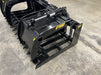 Side view of the Stinger tractor root grapple demonstrating wide jaw opening and hydraulic dual-arm function.